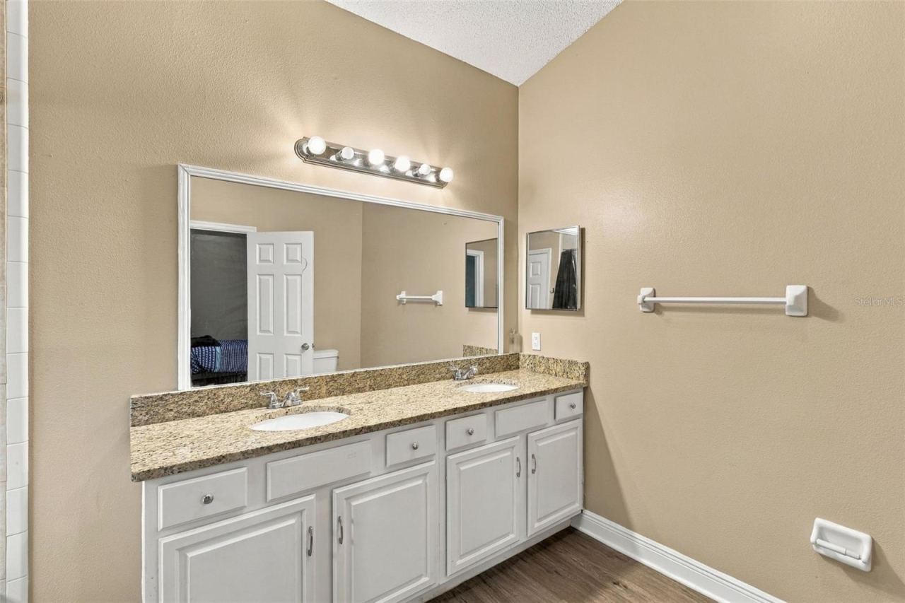 Photo 15 of 20: Primary bathroom, double sink vanity, stone countertop and large soaking tub and shower combo.