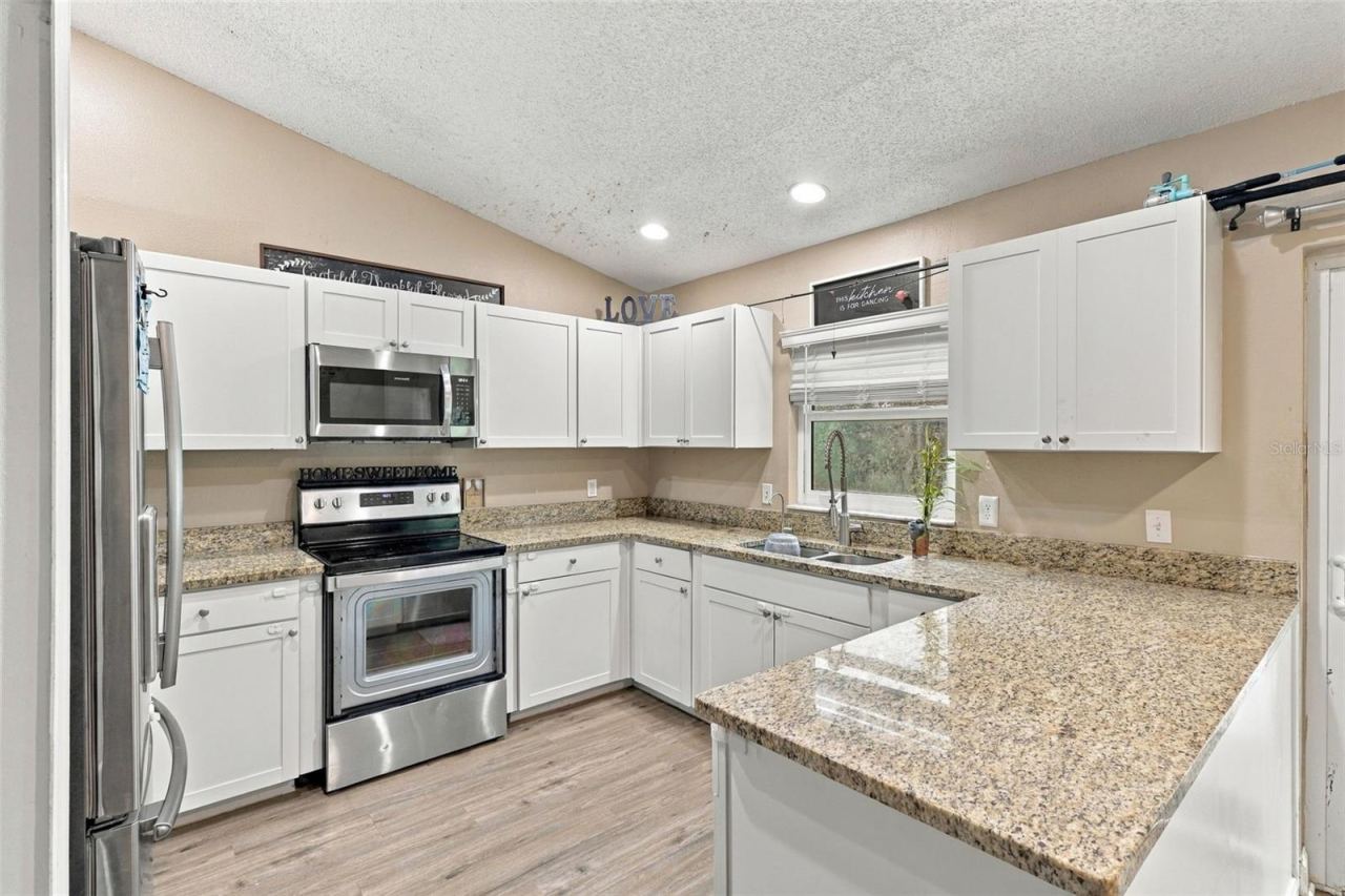 Photo 7 of 20: Stone countertops and stainless steel appliances.