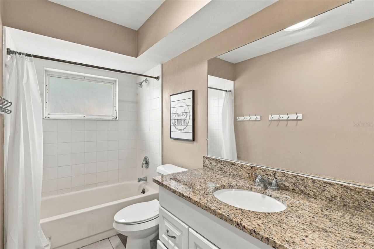 Photo 9 of 20: Bathroom 2- Stone countertops, bath/shower combo