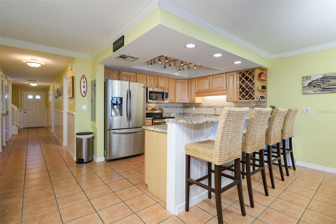 Photo 2 of 20: Walk through the front door from the West, past the primary bedroom, half bath and into the kitchen