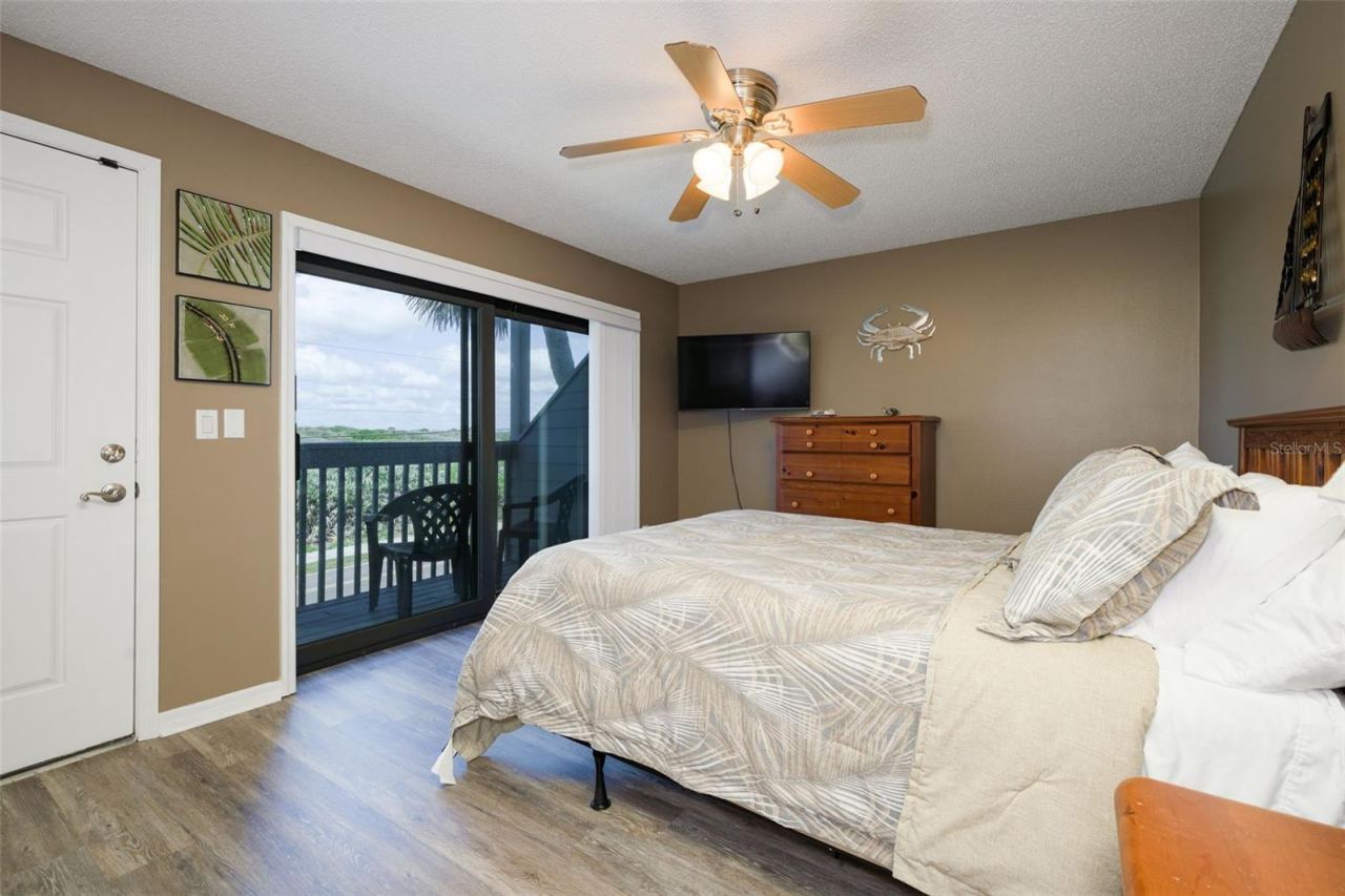 Photo 17 of 20: Bedroom #3 Upstairs with a sunset view balcony