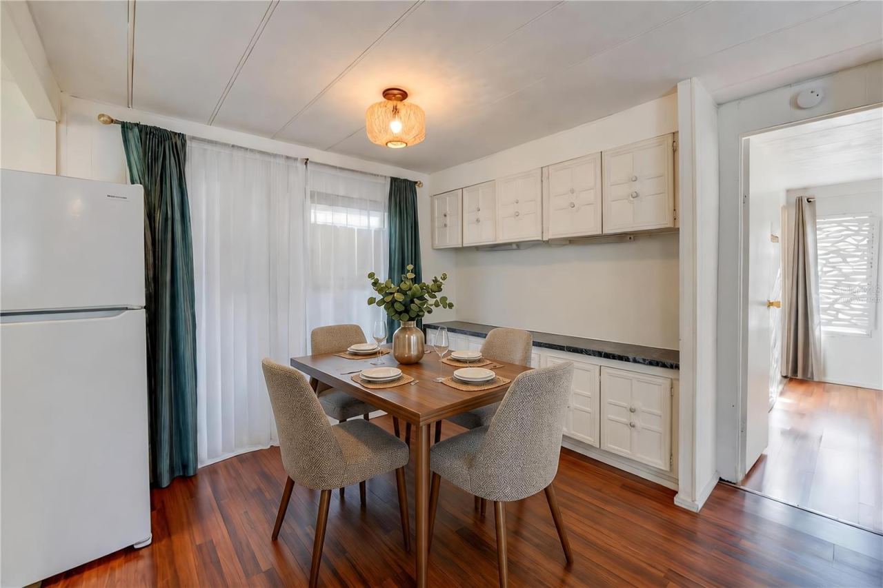 Photo 7 of 20: Virtually Staged - Dedicated dining space features extensive built-in cabinetry and countertop space, with a large window bringing natural light into the room.