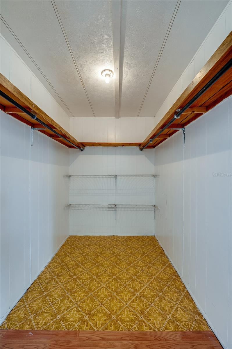 Photo 12 of 20: Generously sized walk-in closet provides hanging space and additional shelving for organized storage.