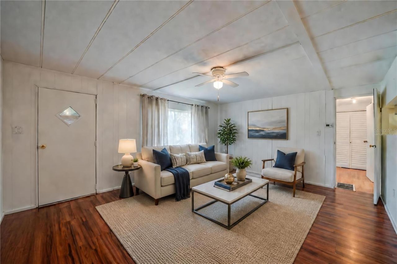 Photo 3 of 20: Virtually Staged - Expansive living room offers plenty of flexibility for multiple furniture arrangements, along with a ceiling fan and a large window overlooking the exterior.