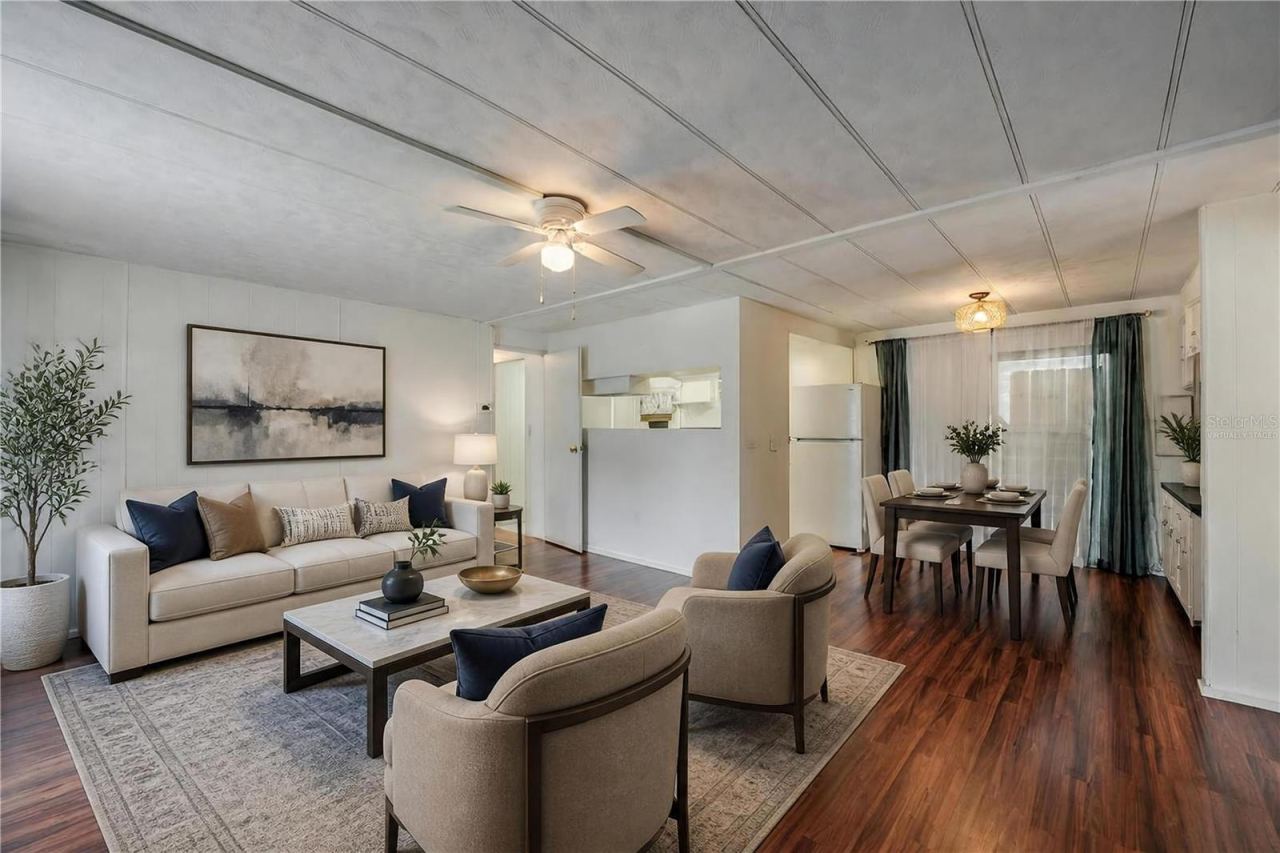 Photo 5 of 20: Virtually Staged - Wide-angle view highlights the open flow between the living, dining, and kitchen spaces, complemented by natural light from the large window.