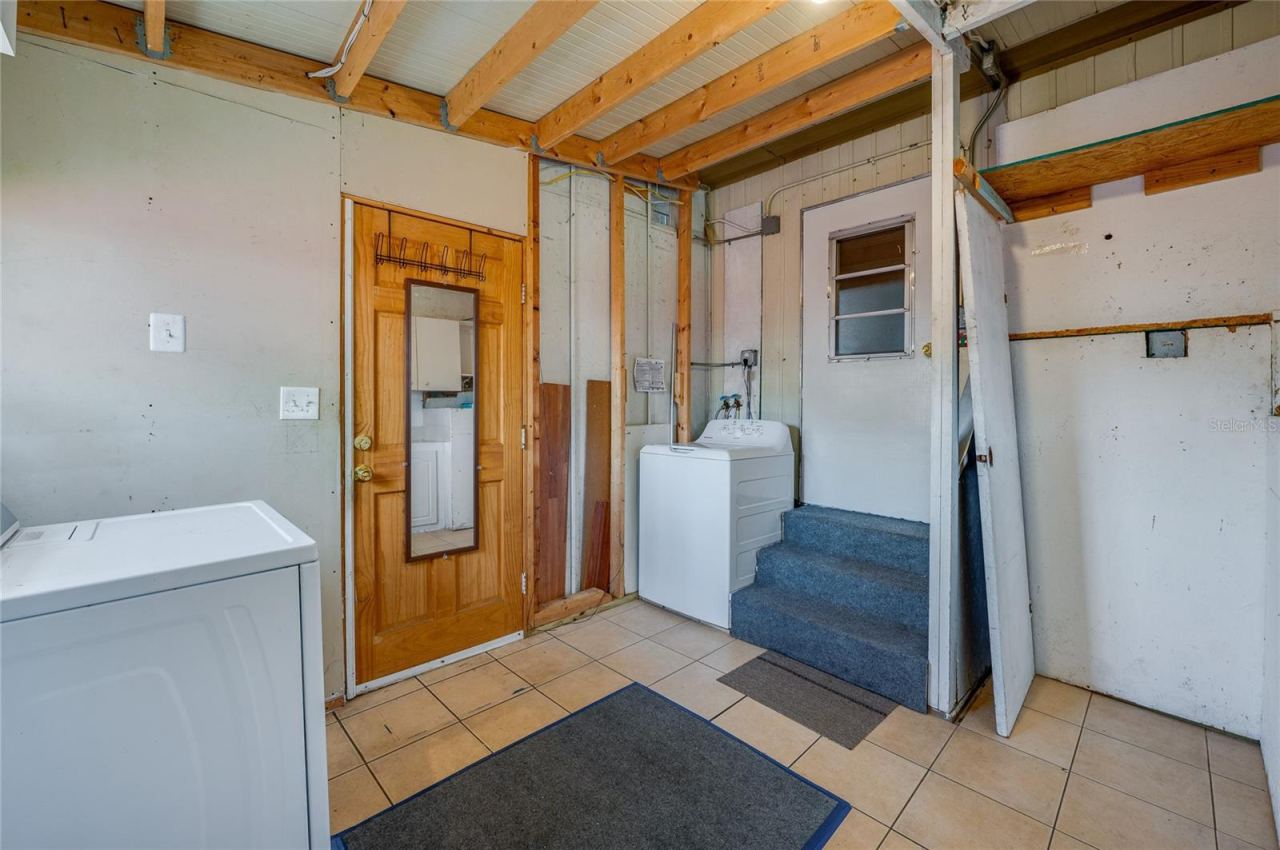 Photo 18 of 20: Separate laundry area provides space for laundry appliances along with additional room for household storage and utility needs.