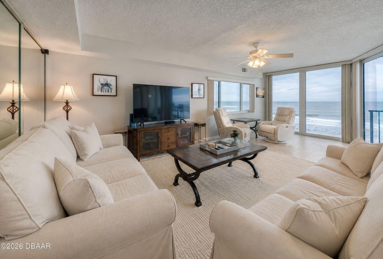 Photo 7 of 20: The living area features full-length windows with unobstructed ocean views and access to the balcony an ideal setting for relaxing or hosting guests.