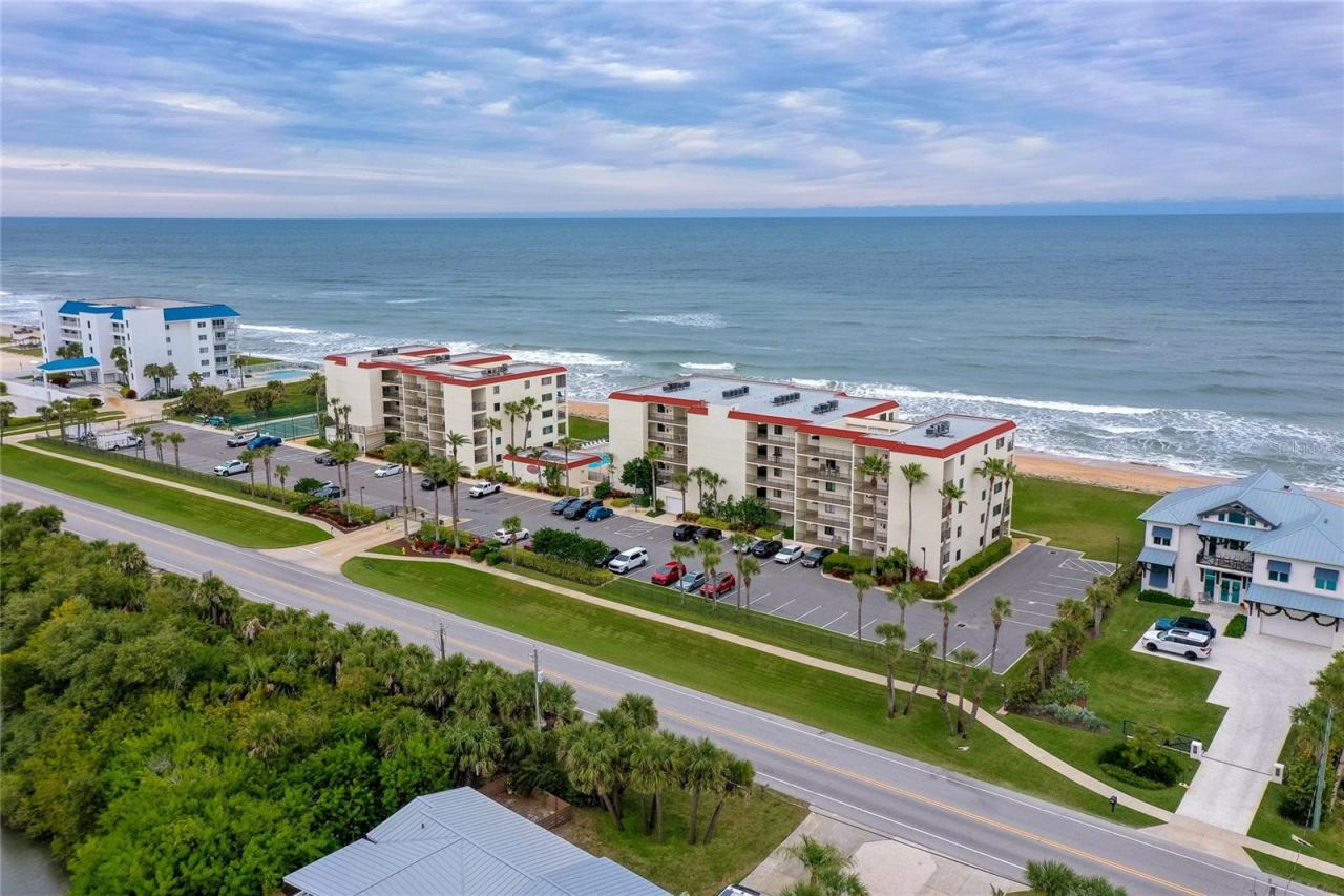Photo 2 of 20: A wider angle highlights the community’s prime beachfront location, surrounded by natural dunes and scenic coastline.