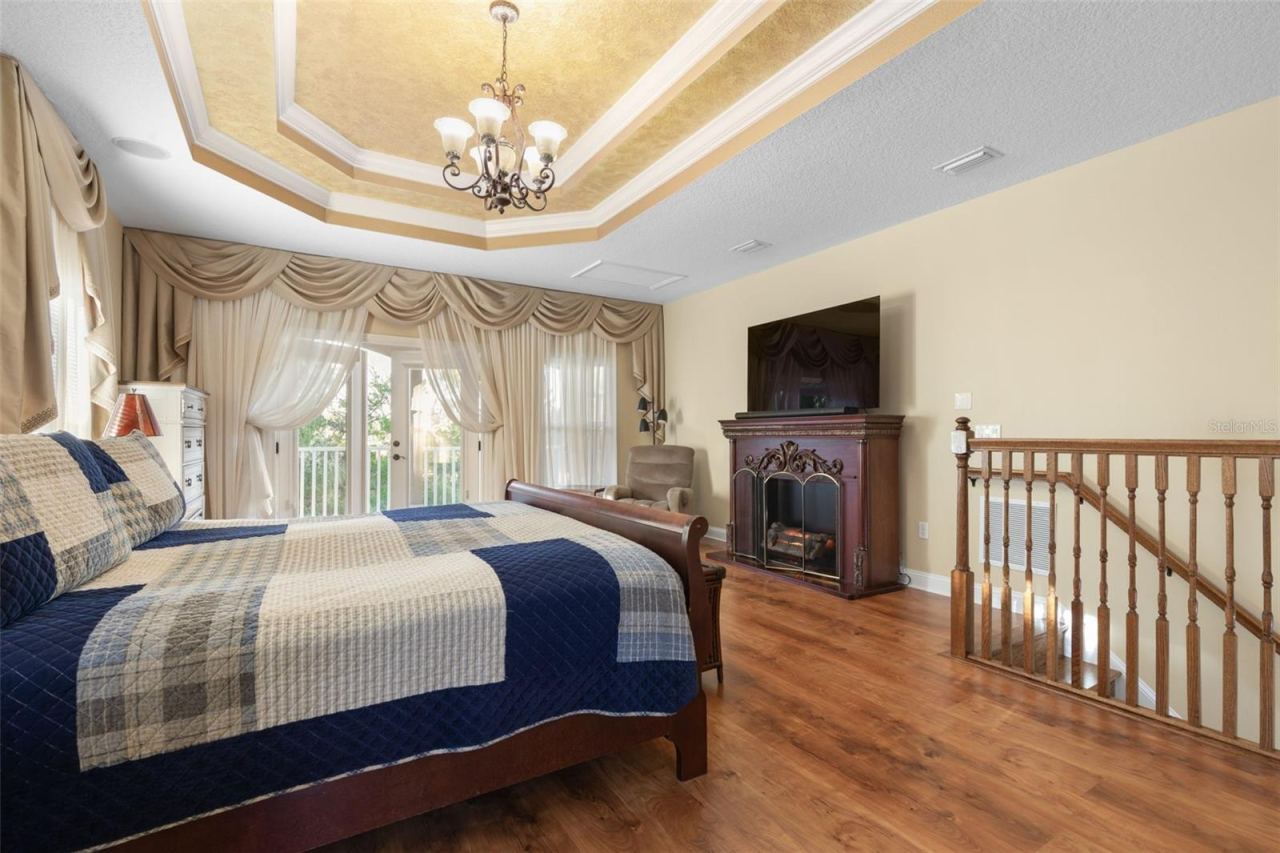 Photo 18 of 20: French doors open to a private balcony overlooking the wooded surroundings, offering a peaceful escape just steps from the bedroom.