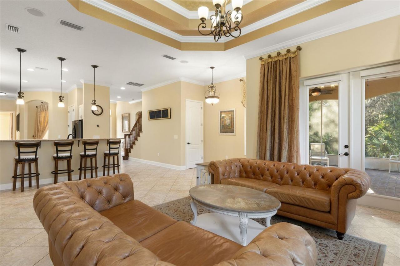 Photo 12 of 20: French doors open to the screened lanai, while the adjoining kitchen and breakfast bar create a natural flow for everyday living and entertaining.