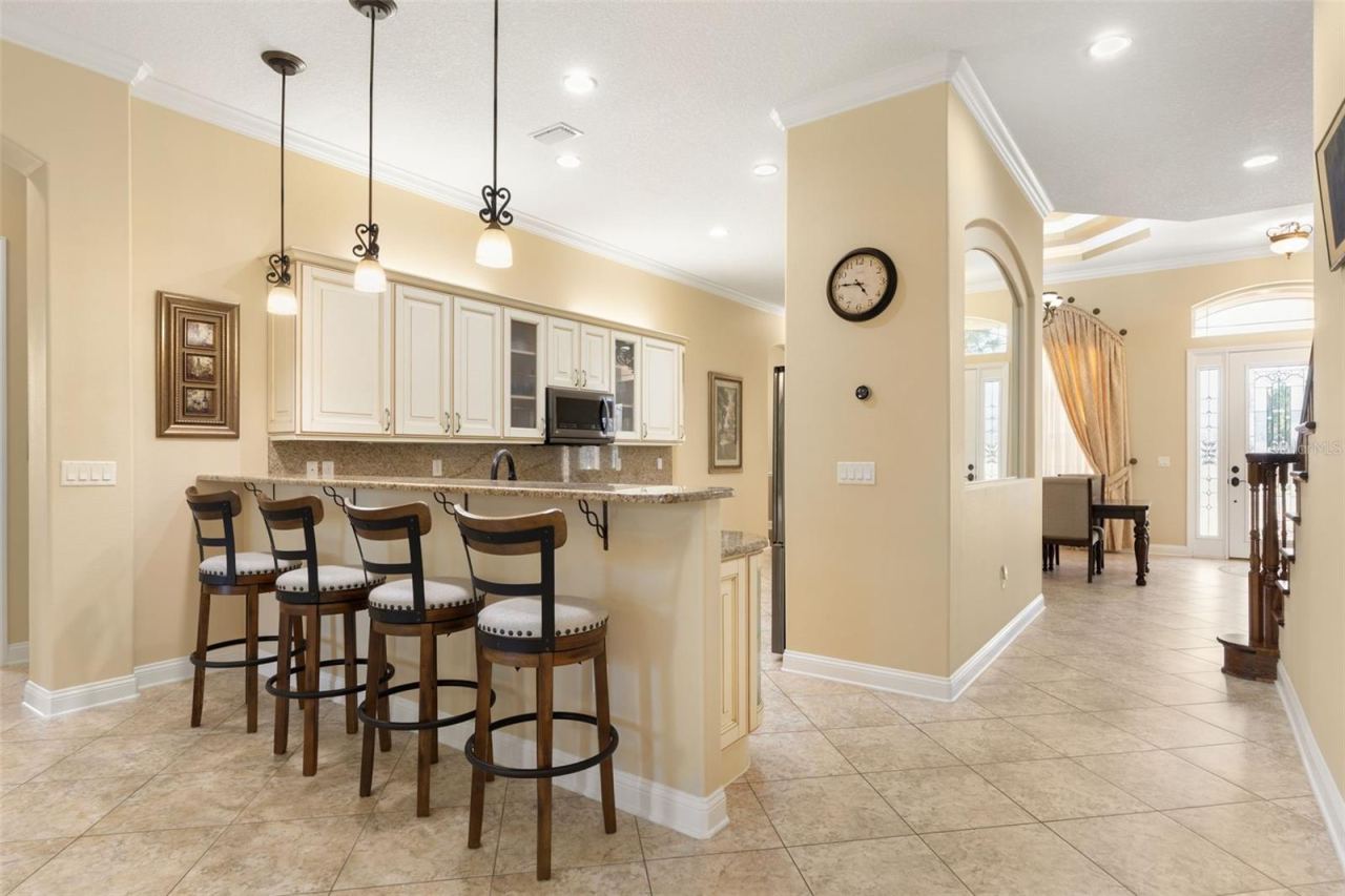 Photo 10 of 20: An inviting connection between the kitchen and gathering room creates a welcoming setting for conversation, entertaining and everyday living.