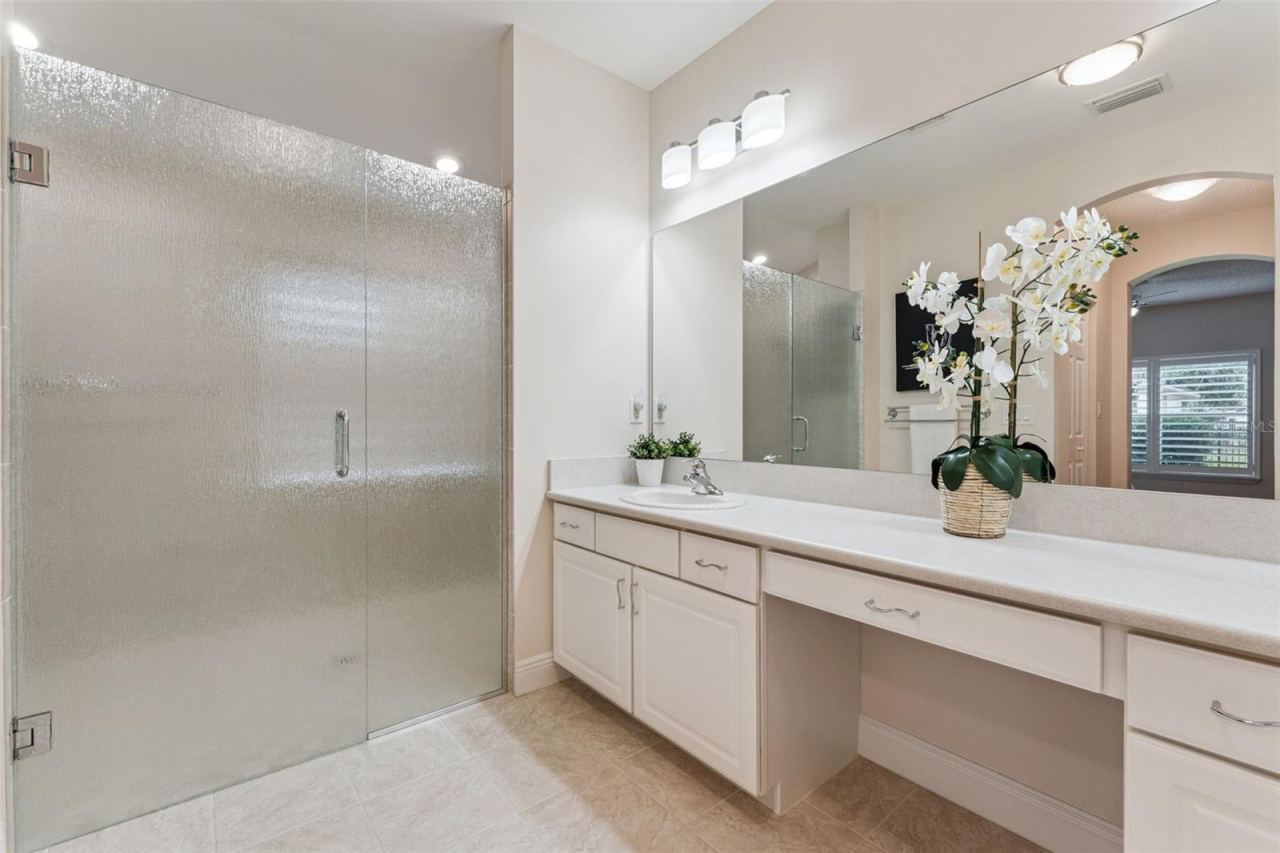 Photo 20 of 20: Primary Bathroom w/ a large frameless glass enclosured walk-in shower