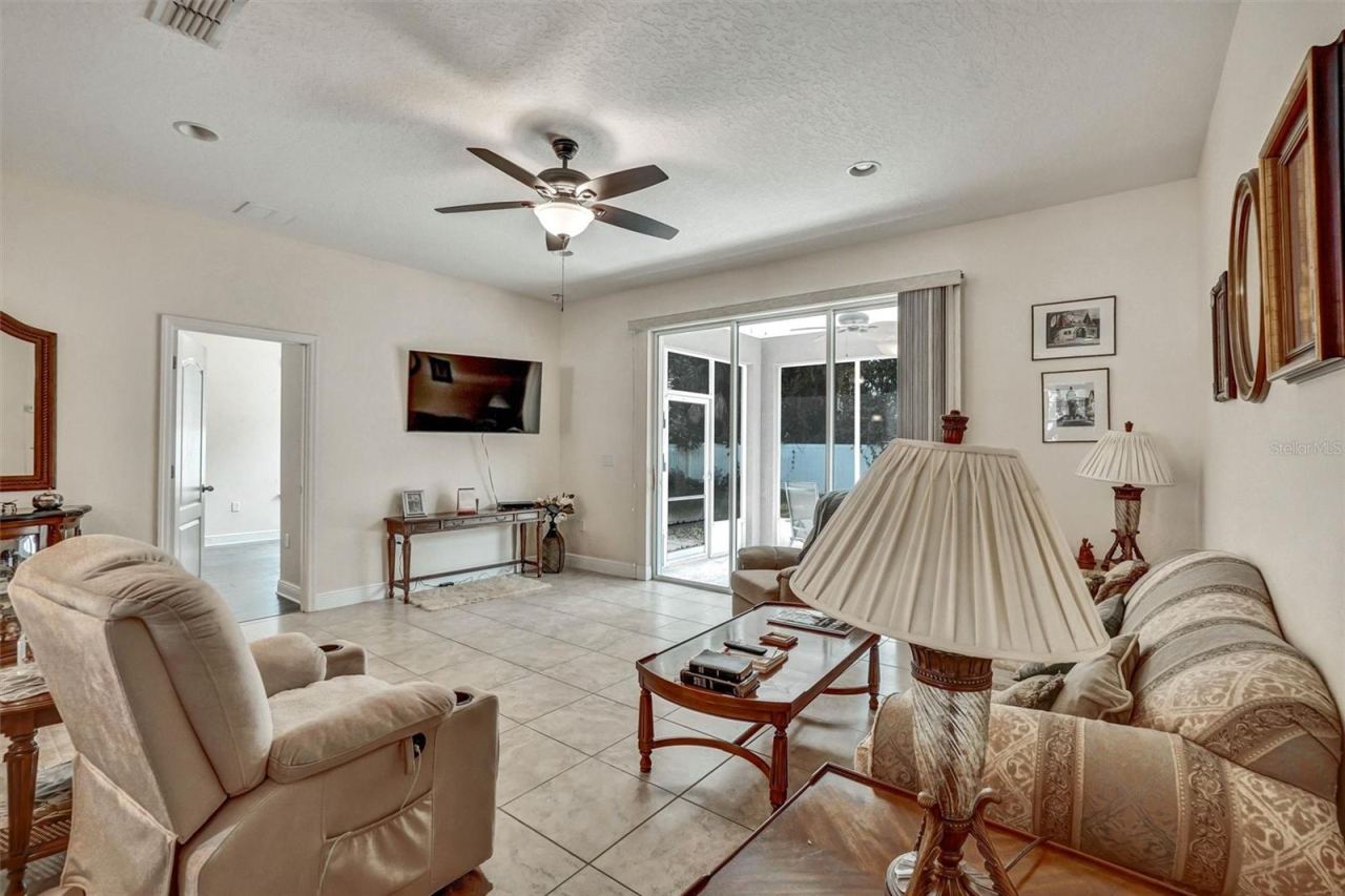 Photo 7 of 20: Living RoomSpacious living room with tile flooring and sliding glass doors.