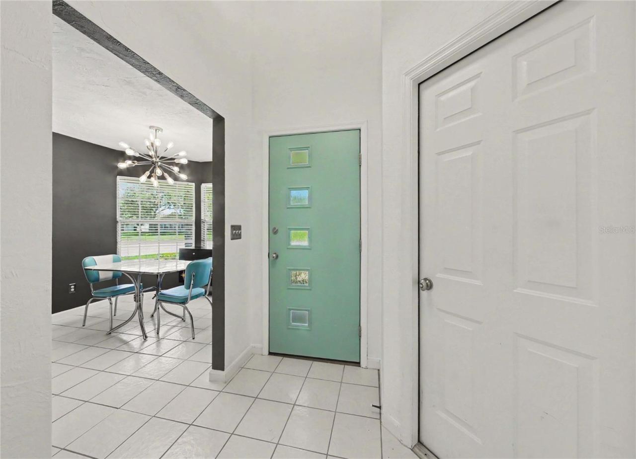 Photo 14 of 20: Welcoming foyer featuring a distinctive retro-style front entry door.