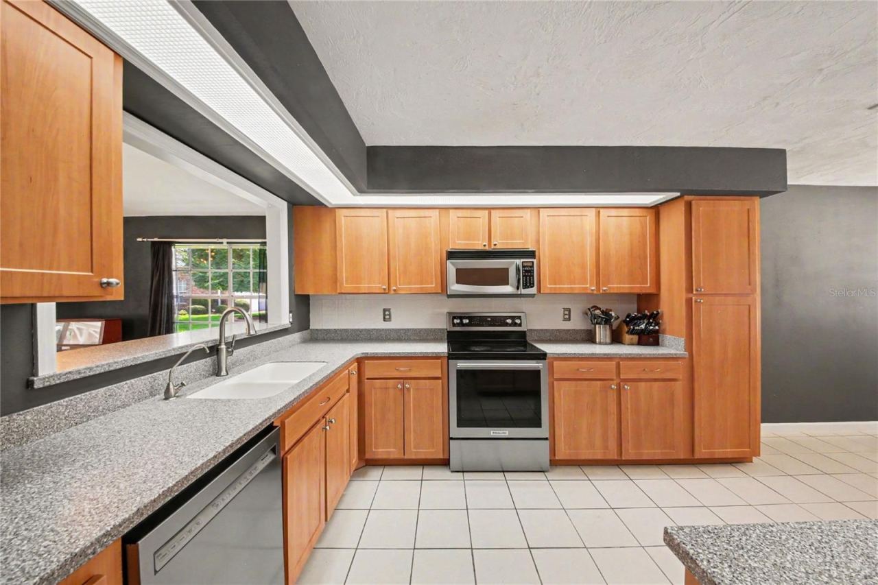 Photo 19 of 20: A convenient kitchen pass-through opens to the great room, creating a more connected and inviting living space.