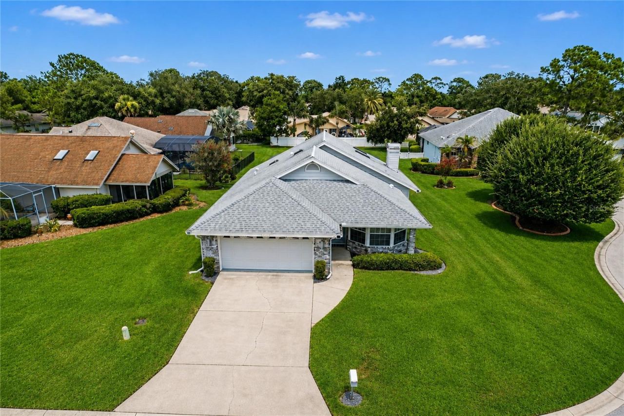 Photo 1 of 20: Welcome to this lovely Spruce Creek Fly-In home, ideally situated on nearly half an acre with exceptional space, privacy, and room to grow!