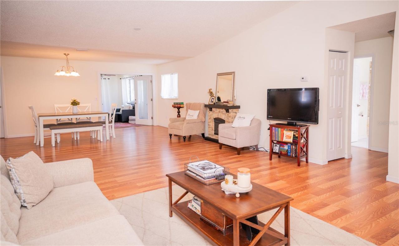 Photo 8 of 20: This bright, inviting view highlights the home's natural light, spacious office area, and beautiful plank vinyl flooring.