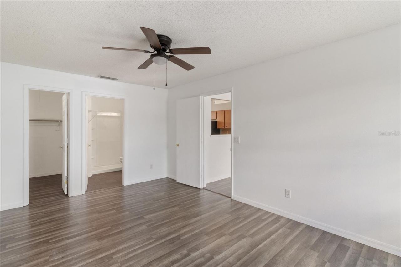 Photo 6 of 20: Primary Bedroom with View To Living Room, Bath, and Master Closet