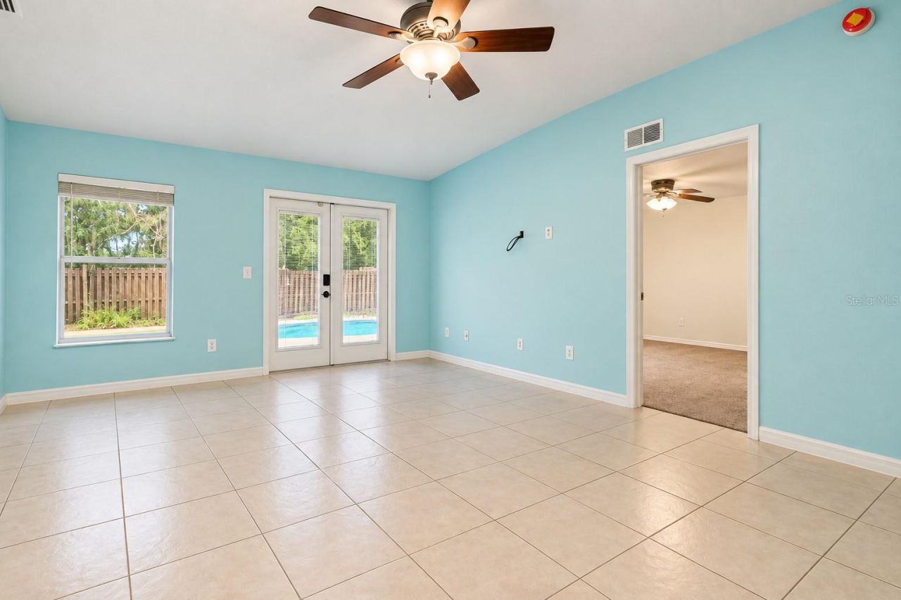 Photo 18 of 20: Living Room with French Doors leading to pool deck.